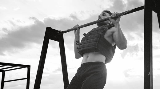 Man Doing Pull-Ups in a Weighted Vest