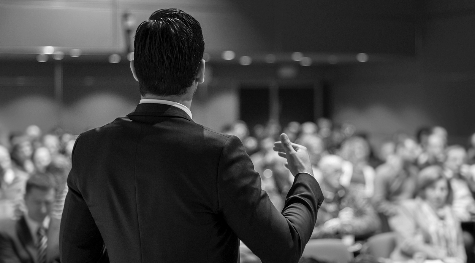 Man Speaking in Front of an Audience