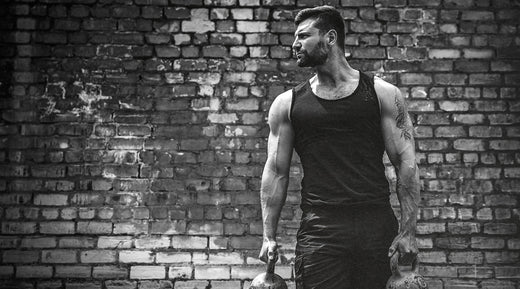 Fit Man Holding Kettlebells