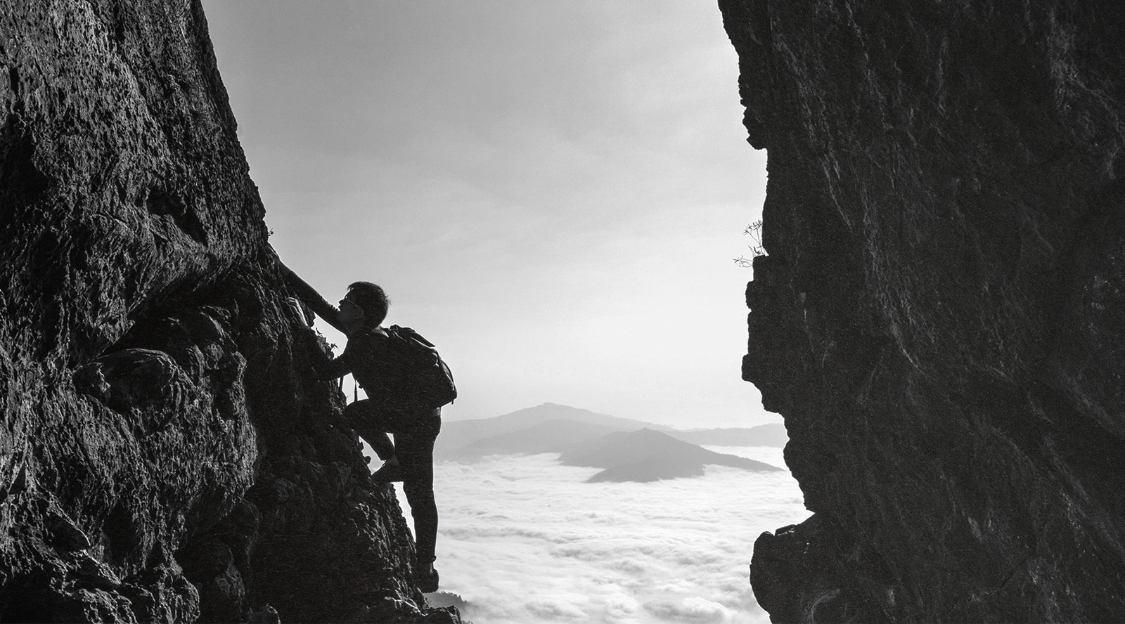 Man Climbing a Rock Wall